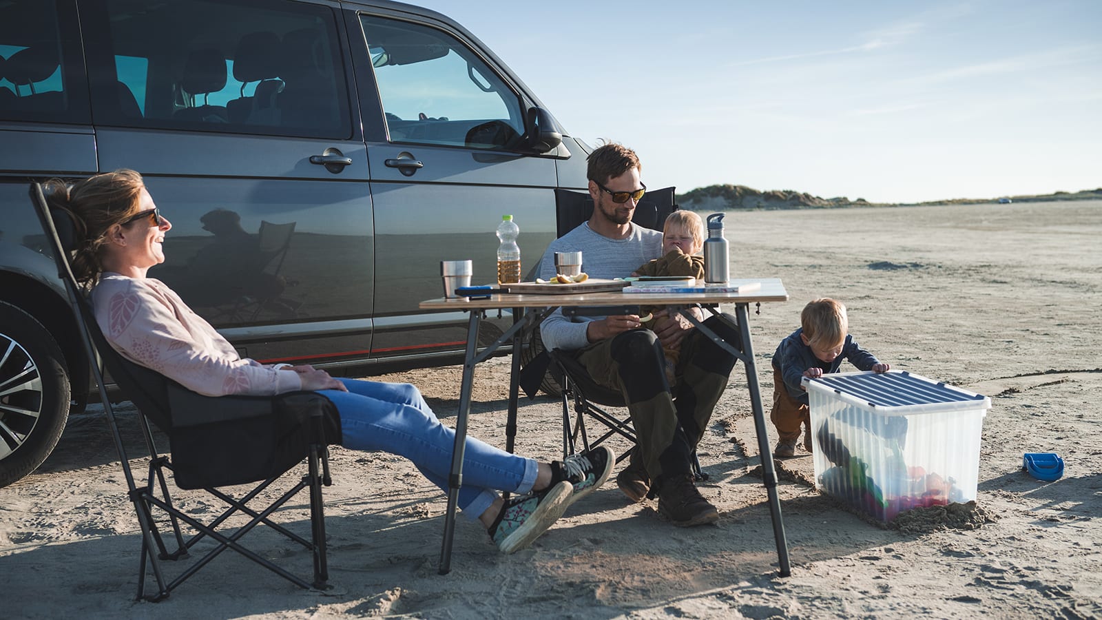 Berghaus Outdoor Sales Store -Berghaus Outdoor Sales Store Familie sitzt am Strand